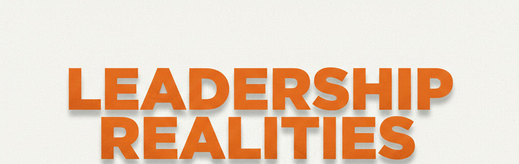 Bold orange 3D typography reading 'LEADERSHIP REALITIES' centered on a clean, light off-white textured background.